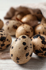 Obraz premium Fresh quail eggs on white wooden table, closeup