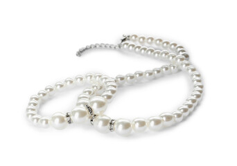 Elegant pearl necklace and bracelet on white background