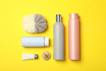 Flat lay composition with baby cosmetic products on yellow background