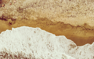 Aerial view. Sea waves and sandy beach