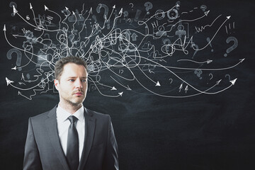 Portrait of attractive thoughtful young european businessman standing on chalkboard/blackboard wall background with arrows mesh sketch. Confusion and question concept.