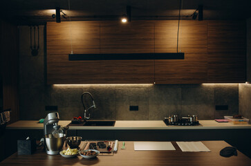 Modern kitchen with black furniture and wooden floor
