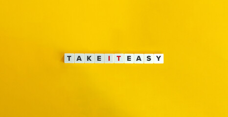 Take It Easy Idiom on Letter Tiles on Yellow Background. Minimal Aesthetics.