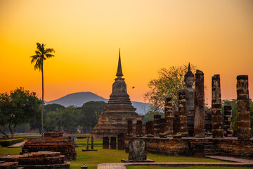 Sunset at Wat Mahathat buddha and temple in Sukhothai Historical Park