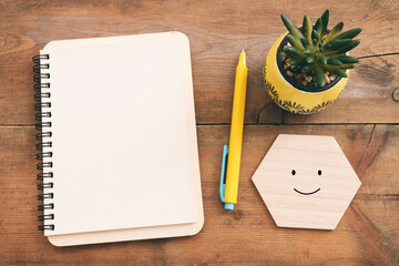 top view image of open notebook with blank pages on wooden desk. ready for adding text or mockup.