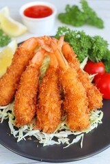 Panko fried shrimps,crispy breaded prawns or Ebi Furai Japanese food on plate with white wood table background