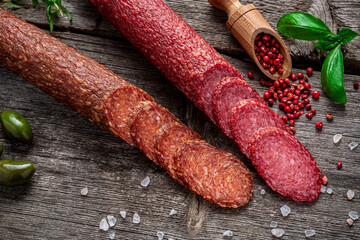 Best quality italian salami on old wooden table.