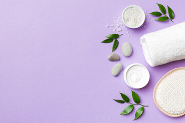 Coconut with jars of coconut oil and cosmetic cream on colored background. Top view. Free space for your text. Natural spa coconut cosmetics and organic treatment concept Coconut Spa composition