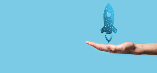 Startup business concept, Businessman holding in hand icon rocket is launching and soar flying out...
