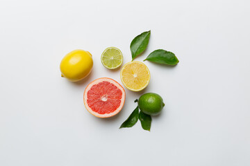 Fruit background. Colorful fresh fruits on colored table. Orange, lemon, grapefruit Space for text healthy concept. Flat lay, top view, copy space