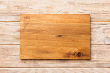 Top view of wooden cutting board on wooden background. Empty space for your design.=