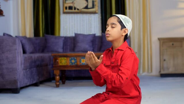 Muslim family in India - A small kid in ethnic wear offering Namaz during the festive season - Eid celebrations. A young boy praying - Offering his prayers to the Almighty  Islamic culture  faith  ...