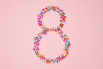 Number 8 or eight made from decorative multi-colored stars. Holiday numbers or figures. Top view