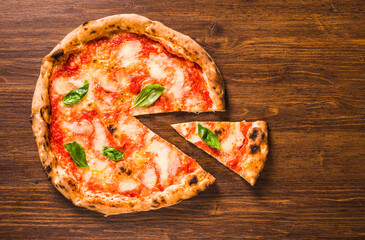Pizza with cheese, tomato and basil copy space wooden background.	