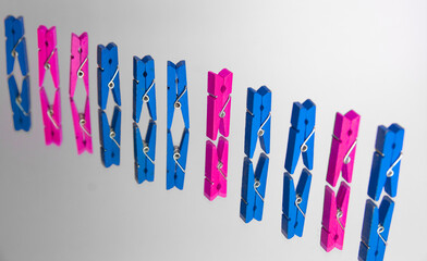 colorful wooden clothespin - abstract vision of man and woman. standing out from the crowd,...