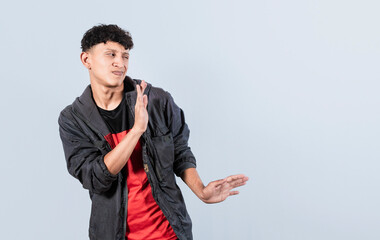 Disgusted man with rejection gesture, pulls palms in rejection, displeased guy rejecting something