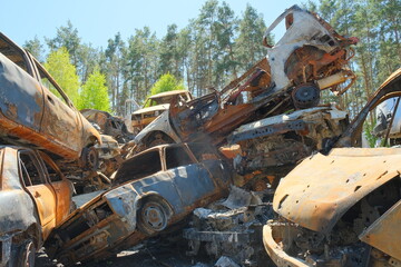 Fototapeta premium City dump of destroyed cars of civilians in Irpin, Ukraine. War in Ukraine