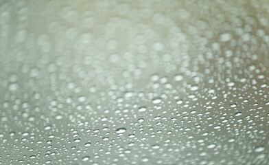 Relaxing background of rainwater drops on a glass