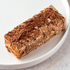 Napoleon with chocolate cake. Delicate and delicious homemade puff pastry dessert with custard....