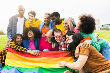 Diverse group of young people having fun at LGBT Pride parade Multi-racial people happy in open air