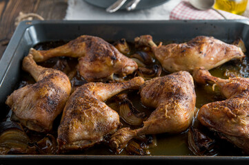 Oven baked chicken legs on a baking tray