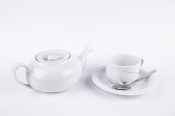 white porcelain teapot and cup on saucer for coffee or tea empty
