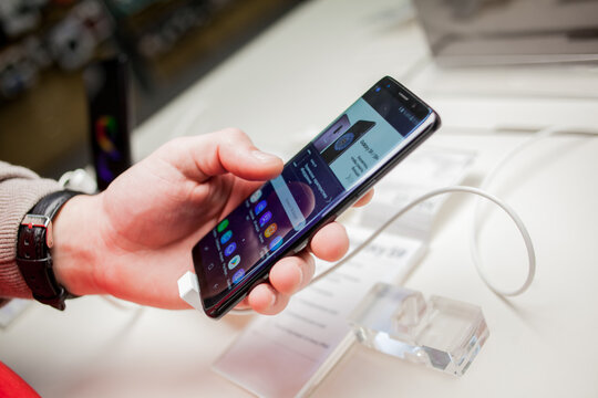 Kiev, Ukraine - March 24, 2018: Presentation of Samsung S9, Samsung C9 + flagships. The man is holding a Samsung S9 phone, a Samsung S9 +. Stand with mobile phones