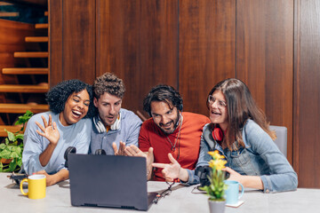 group of young influencers streaming using a laptop