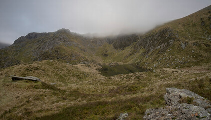 Fototapeta na wymiar Snowdonia mountain scene with thick cloud and mountain lake
