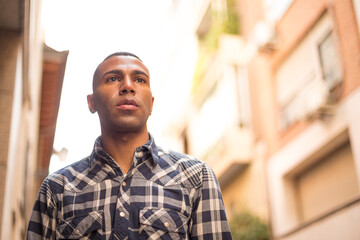 portrait young african american man on the street