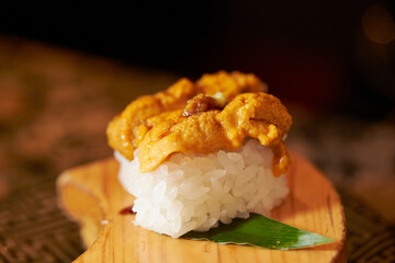 Sea urchin sushi on a wooden cutting board