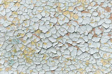 Blue old faded cracked painted surface pattern on building exterior interior wall with aged scratched paint layers. Abstract old plaster stucco imperfection background. Grunge scratched wallpaper