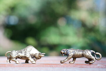 Metal bull and tiger figurine close-up. Financial symbol.