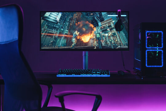 Empty home gaming studio of cyber sportsman in neon lights. Professional gaming setup for playing online video games and live streaming. Shooters, cyber sport, esport concept