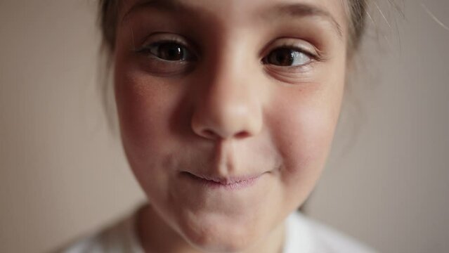 child girl playing funny a squinting eyes. strabismus squint happy family kid dream concept. daughter little girl having fun smiling lifestyle twisting her eyes funny content