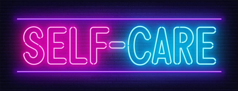 Self Care neon sign on brick wall background.