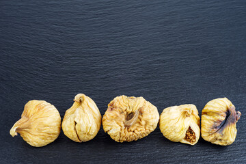 Close up of dried figs on a black background