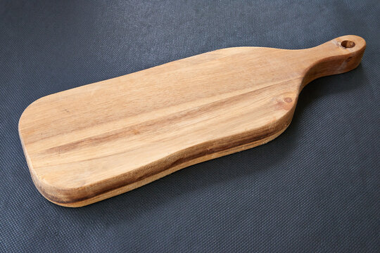 Wooden bread plank on black background