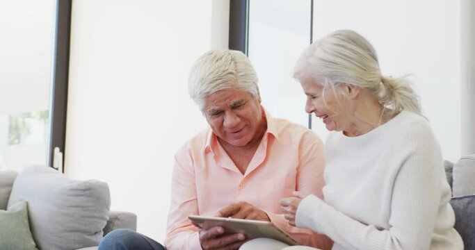 Happy Senior Diverse People Talking And Using Tablet At Retirement Home