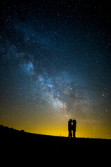 Obraz na płótnie Canvas Milky way and couple in Serra Del Montsec, Lleida, Spain
