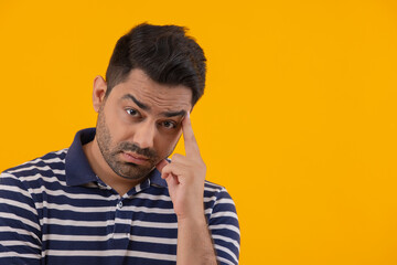 Portrait of worried man with hand on cheek