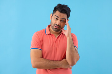 Portrait of worried man with hand on forehead