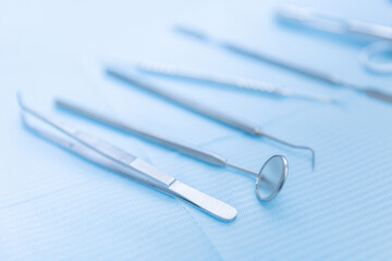 Closeup different dental instruments and tools, blue toning. Concept dentists room office