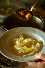 Traditional fish dish from Serbia food (serbian cuisine) and Hungarian cuisine - hot chili paprikaš fish soup with fresh catch of the day of Danube fish, red paprika and homemade pasta