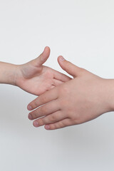 Children's hands gesticulating on a white background. Male greeting.