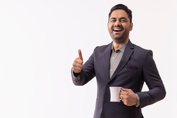 Portrait of a cheerful young businessman looking at camera and showing thumbs up