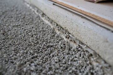 Construction site of attic conversion in the phase of floor screed fill and drywall is already in...