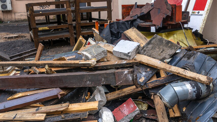 Construction garbage is piled up at site after building repair. Trash heap. Pile of home rubbish thrown after renovation.