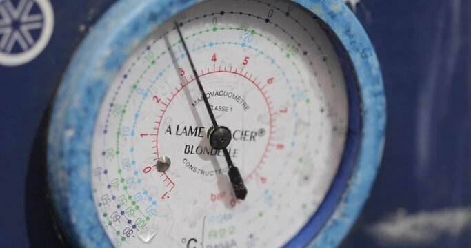 Pressure gauge in a factory, arrow movement on an industrial pressure gauge. Industrial pressure gauge