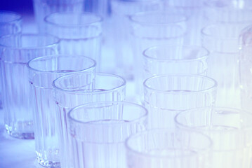 Photo of faceted glasses in blue, cold light
